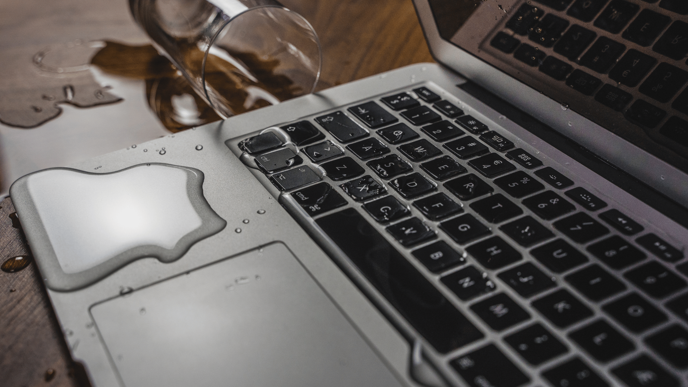 Cup of water spilling on macbook keyboard